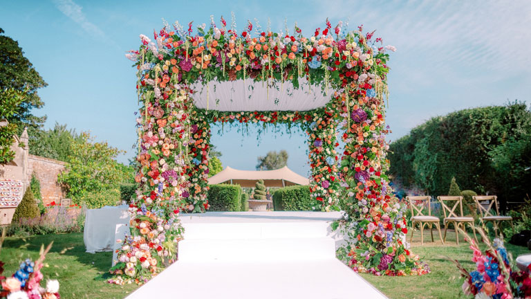 colourful chuppah outdoors at a jewish wedding ceremony