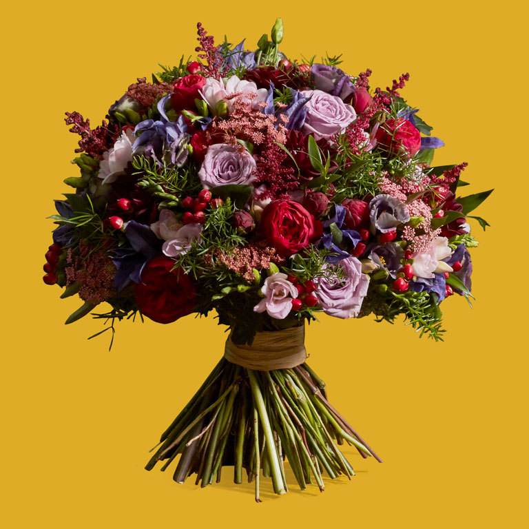 An explosion of colour featuring seasonal clematis, roses, dahlia, astilbe and herbs