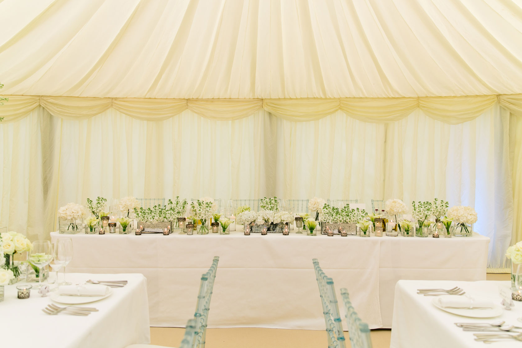 a wedding top table inside a marquee